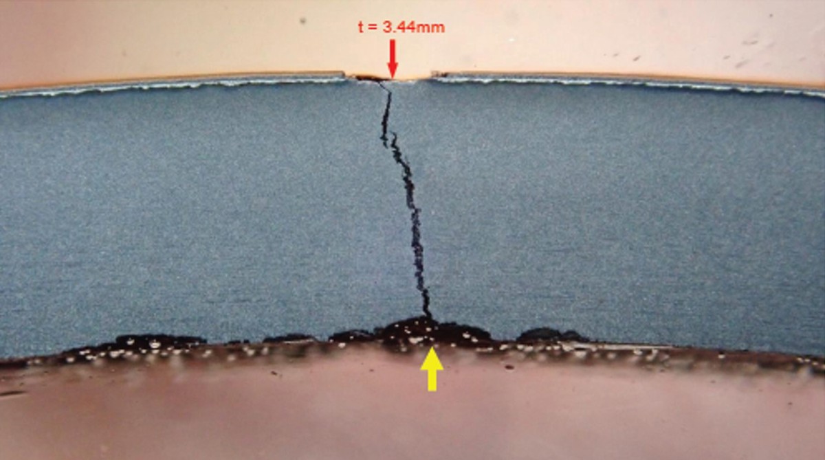 IMCA SF Failure of in-service saturation bailout bottle image 3 A cross-section through the cylinder wall at the leak location showing a through-thickness crack. The cylinder suffered internal corrosion at the crack location, with a measured remaining wall thickness of 3.44 mm.