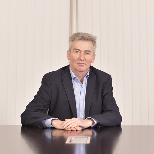 A photo of Iain Grainger, IMCA CEO, sitting at a desk