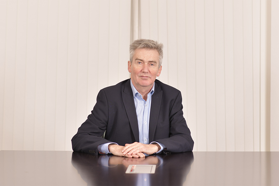 A photo of Iain Grainger, IMCA CEO, sitting at a desk