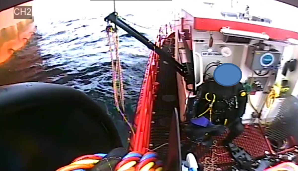 showing mooring line caught on diver rescue davit in deployed position