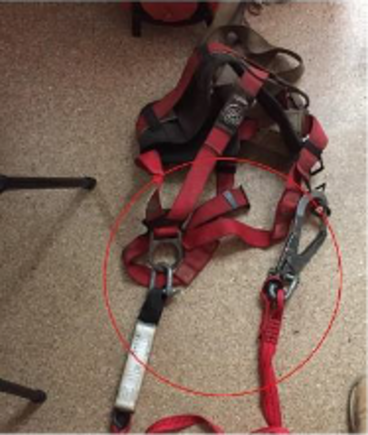 During a barge inspection, a third-party owned safety harness was found inside a container, without manufacturer’s tag and with cargo D-shackles on the lanyard instead of proper carabiners