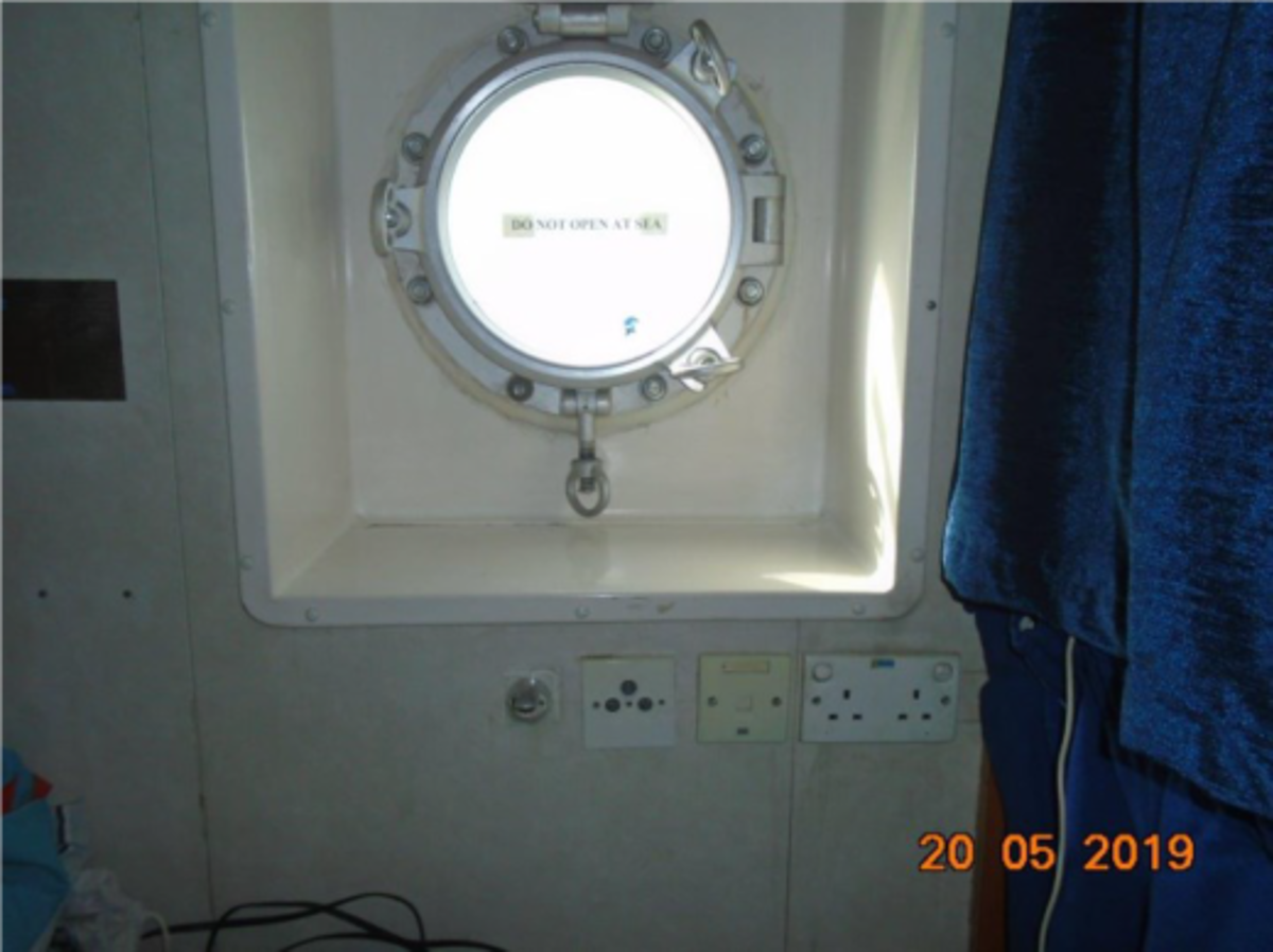 a cabin porthole was left slightly ajar, allowing seawater to enter the cabin and seep into the electrical socket under the porthole causing a short circuit resulting in burnt wiring and smoke in the cabin