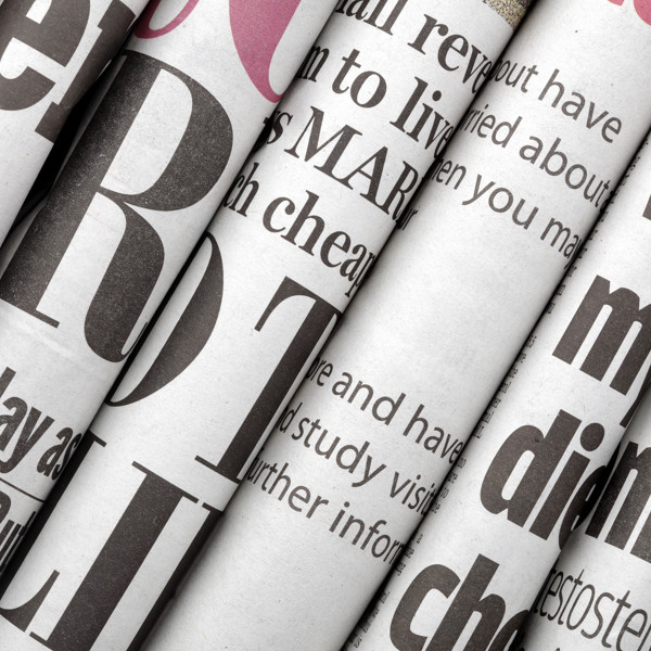 Close up of newspapers rolled on their side