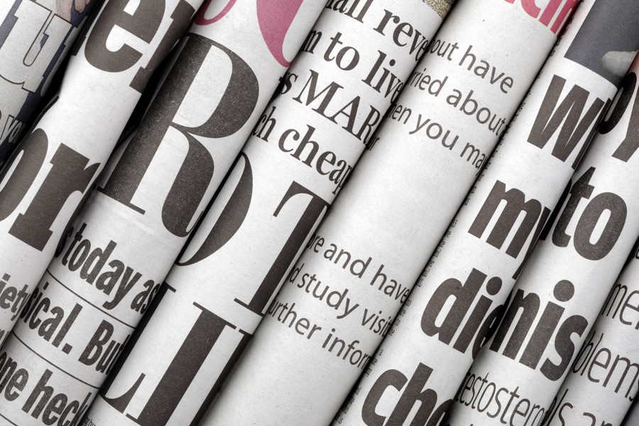 Close up of newspapers rolled on their side