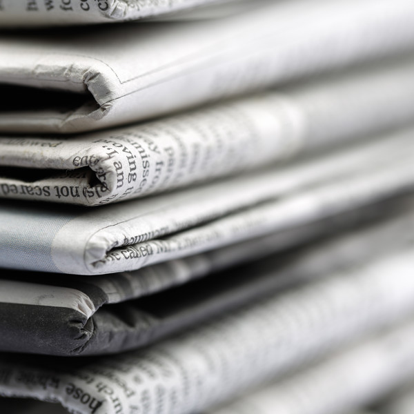 Close up of newspapers folded into a pile