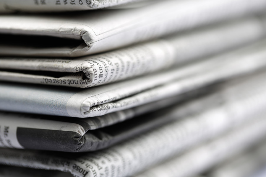 Close up of newspapers folded into a pile