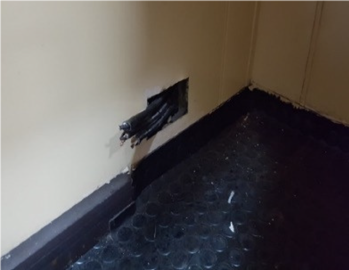 Whilst tidying a mobile office (freight) container, an employee sustained a mild electric shock by inadvertently touching an exposed live electrical cable which was obscured by several boxes below a desk